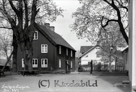 Sockenstugan Södra Vi
gepe
Två hus, t v ett stort rött trähus och mitt fram ett vitt trähus. 
Framför ena kortsidan på det röda huset står ett stort träd med en bänk runt om-
Nyckelord: Söckenstugan Södra Vi
