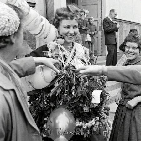 Realexamen Kisa
raja
En kvinna som bär ljus klänning har blommor och ballonger runt halsen. 
amwa
Marianne Andersson
Nyckelord: Kisa